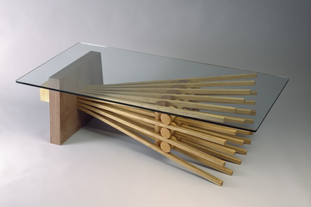Rectangular glass top coffee table with stone and bent wood, available in custom sizes from Seth Rolland furniture maker