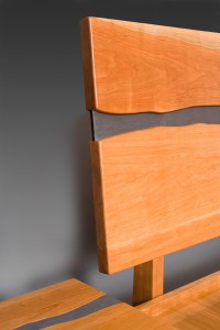 Detail of Cayuga cherry bed and nightstand with stone, custom made by Seth Rolland furniture design