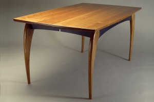 Solid cherry wood dining table with sculpted legs by Seth Rolland custom furniture design