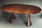 Expanding oval wood dining table in solid walnut by Seth Rolland custom furniture design